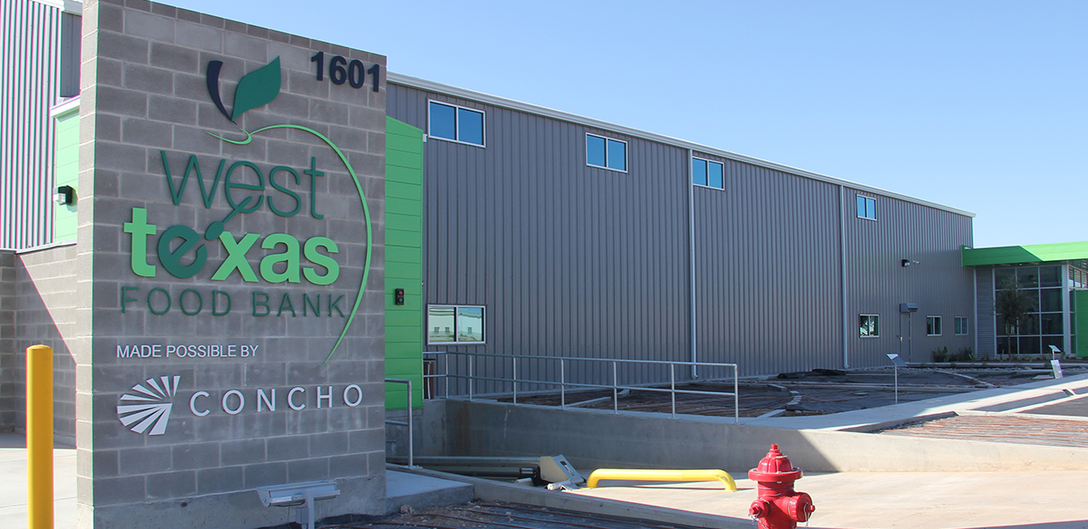 Industrial metal-sided building with sign for the West Texas Food Bank.